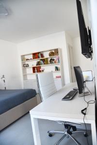 a bedroom with a desk with a computer on it at Olga Suite in San Pietro Vernotico