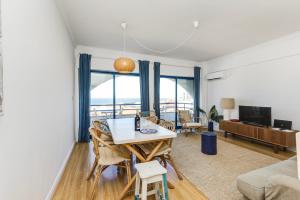 a living room with a table and chairs at Apartamento Mar Salgado Ericeira in Ericeira
