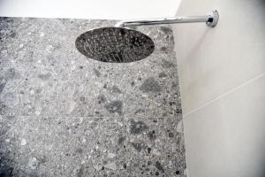 a shower with a drain in a bathroom at Olga Suite in San Pietro Vernotico +19 photos
