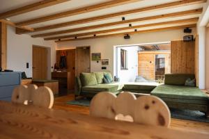 a living room with a couch and a table at Chalet Astra, Whirlpool & Sauna in San Pancrazio dʼUltimo