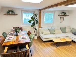 a living room with a table and a couch at Altstadt Appartement in Ingolstadt +12 photos