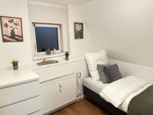 a white room with a bed and a window at Altstadt Appartement in Ingolstadt