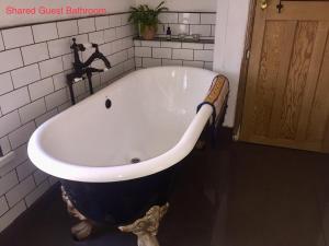 a large bath tub in a bathroom with at Cardiff Mini Retreat in Cardiff