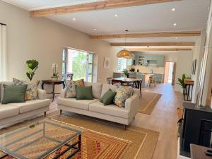 a living room with two couches and a table at Scandi House in Louis Trichardt