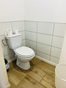 a bathroom with a white toilet in a room at Maisonnette La Chouette in Azille