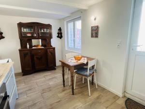 a kitchen with a wooden table and a dining room at Maisonnette La Chouette in Azille