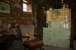a living room with a chair and a dresser at John Jack Inn Accommodation in Chrissiesmeer
