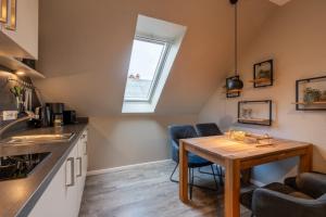 a kitchen with a table and chairs and a window at Pier17 Appartement 3 in Borkum