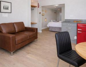 a room with a couch and a table and a bed at The View at 52, Whitby in Whitby