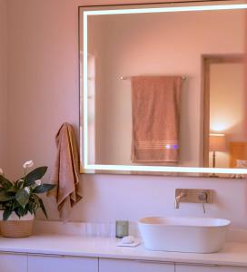 a bathroom with a white sink and a mirror at Scandi House in Louis Trichardt +14 photos