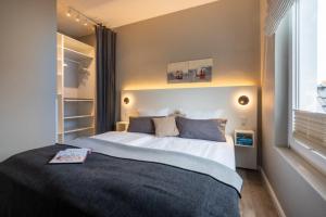 a bedroom with a bed with a book on it at Pier17 Appartement 5 in Borkum