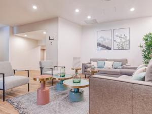 a living room with a couch and tables and chairs at Limehome Barcelona Carrer de Fontcoberta - Digital Access in Barcelona