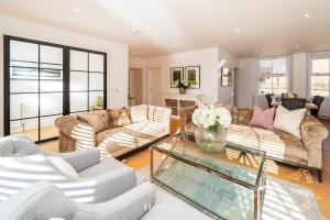 a living room with couches and a glass table at The Old Sorting Office, Aboyne, Royal Deeside in Aberdeen