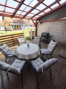 a patio with a table and chairs and a grill at Apartment by MICHELLE - Terme Čatež House in Čatež ob Savi