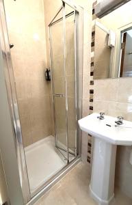 a bathroom with a shower and a sink at Westport Rooms in Westport