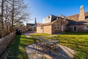 a table and chairs in front of a house at The Old Sorting Office, Aboyne, Royal Deeside in Aberdeen