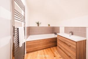 a bathroom with a tub and a sink at The Old Sorting Office, Aboyne, Royal Deeside in Aberdeen +43 photos