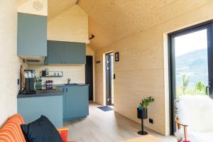 a kitchen and living room in a tiny house at Cabin in the orchard in Sandane +45 photos