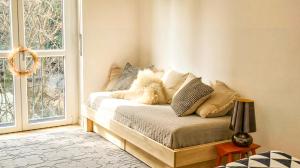 a bedroom with a bed with pillows and a window at Suite and Home between Milano, Malpensa e Como Lake in Saronno