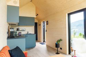 a kitchen and living room in a tiny house at Cabin in the orchard in Sandane
