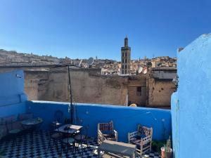 a view of a city from a rooftop with tables and chairs at Riad La Mentha Panoramic Terrace in Fes Medina in Fez