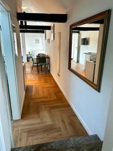 a hallway with a mirror and a dining room at modernes Apartment mit Wlan in Lorsch +8 photos