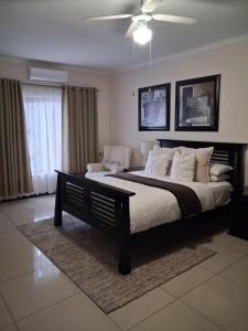a bedroom with a large bed and a couch at The Ridge BnB in Manzini +69 photos