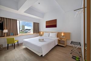 Postel nebo postele na pokoji v ubytování Whiz Prime Hotel Sudirman Pekanbaru + 37 fotografií