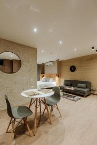 a living room with a table and chairs and a couch at Cozy Loft in Class 48 in Sabaneta