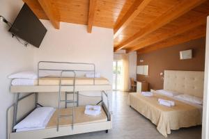 a room with two bunk beds and a flat screen tv at Hotel Favorita Easy Stay B&B in Cesenatico +41 photos
