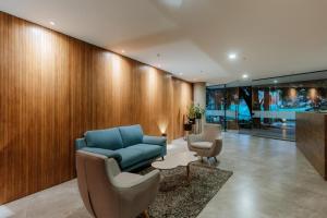 a living room with a blue couch and two chairs at Cozy Loft in Class 48 in Sabaneta +34 photos