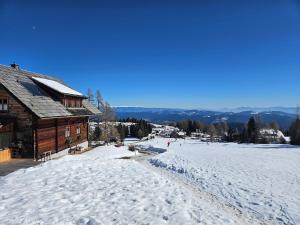 a snow covered ski slope next to a building at Lovely chalet in Alps in Bad Kleinkirchheim
