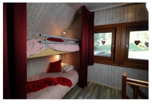 a bedroom with two bunk beds and a window at Lovely chalet in Alps in Bad Kleinkirchheim +16 photos