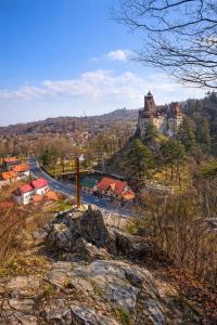a view of a town with a castle on a hill at Casa Krista in Bran