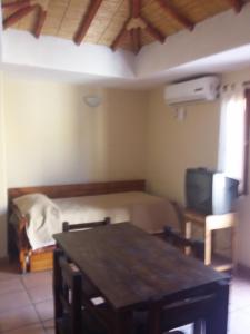 Pokój ze stołem, łóżkiem i telewizorem w obiekcie Cabañas Santa Catalina w mieście Tilcara