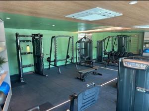 a gym with several tread machines in a room at Beach Class Verano - Resort em Muro Alto por Yolo in Ipojuca