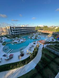 an aerial view of a resort with a pool at Beach Class Verano - Resort em Muro Alto por Yolo in Ipojuca