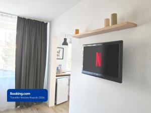 a flat screen tv hanging on a wall in a room at Apartman Point in Štrba