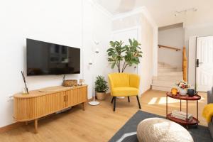 a living room with a flat screen tv on a wall at Casa Anik Boutique Home, La laguna in Las Lagunas