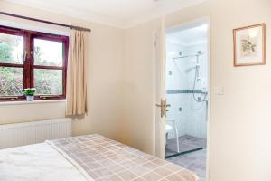 a bedroom with a bed and a shower at 4 Bed in Upton Cross oc-j34643 in Upton +29 photos