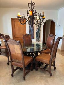 a dining room with a glass table and chairs at Beautifully Maintained 2-Bed Condo in Las Mañanitas in San José del Cabo