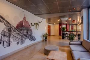 a lobby with a drawing on the wall at B&B Hotel Firenze Nuovo Palazzo Di Giustizia in Florence +22 photos