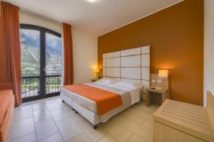 a bedroom with a bed and a large window at Hotel al ritrovo in Castelluzzo +124 photos