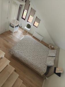 an attic room with a bed and a chair at B6 in Ursel