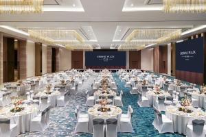 a large banquet hall with white tables and chairs at Crowne Plaza Vientiane by IHG in Vientiane +237 photos