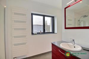 a bathroom with a sink and a mirror at Ty moncher côté cour in Plouhinec +15 photos