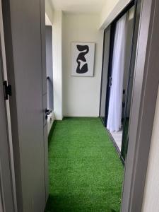 a corridor with green carpet in a room at Luxeliving Homes in Nairobi +7 photos