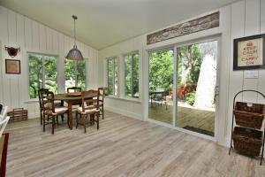 a dining room with a table and chairs at Frog Cottage on the Blanco in Wimberley +14 photos