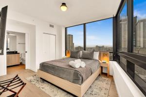 a bedroom with a large bed and large windows at Miami Oasis 2BR Apt Pool & Beach Access for 5 in Miami