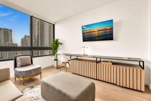 an apartment living room with a large window at Miami Oasis 2BR Apt Pool & Beach Access for 5 in Miami +53 photos